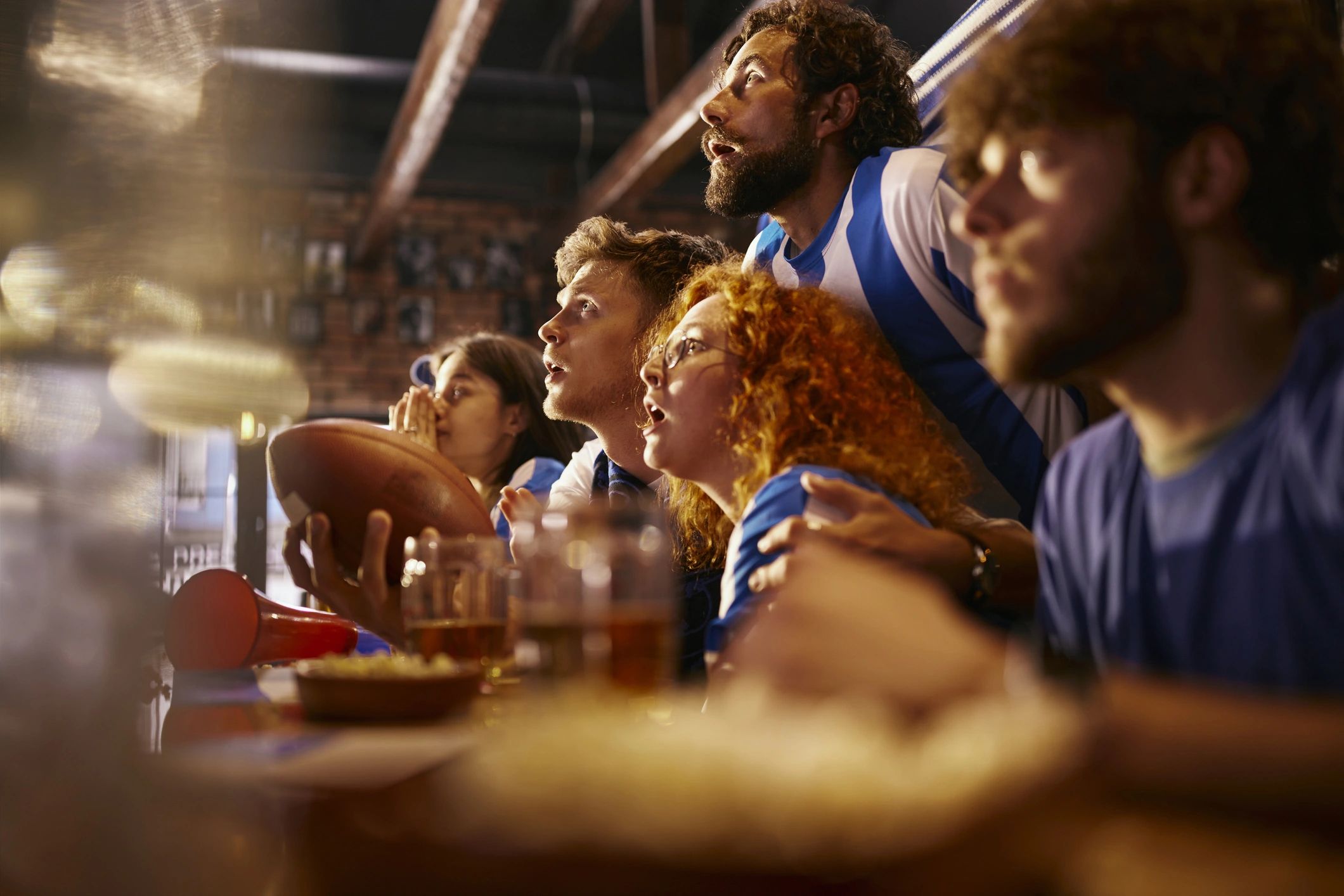 Fans watching a tense rugby match together